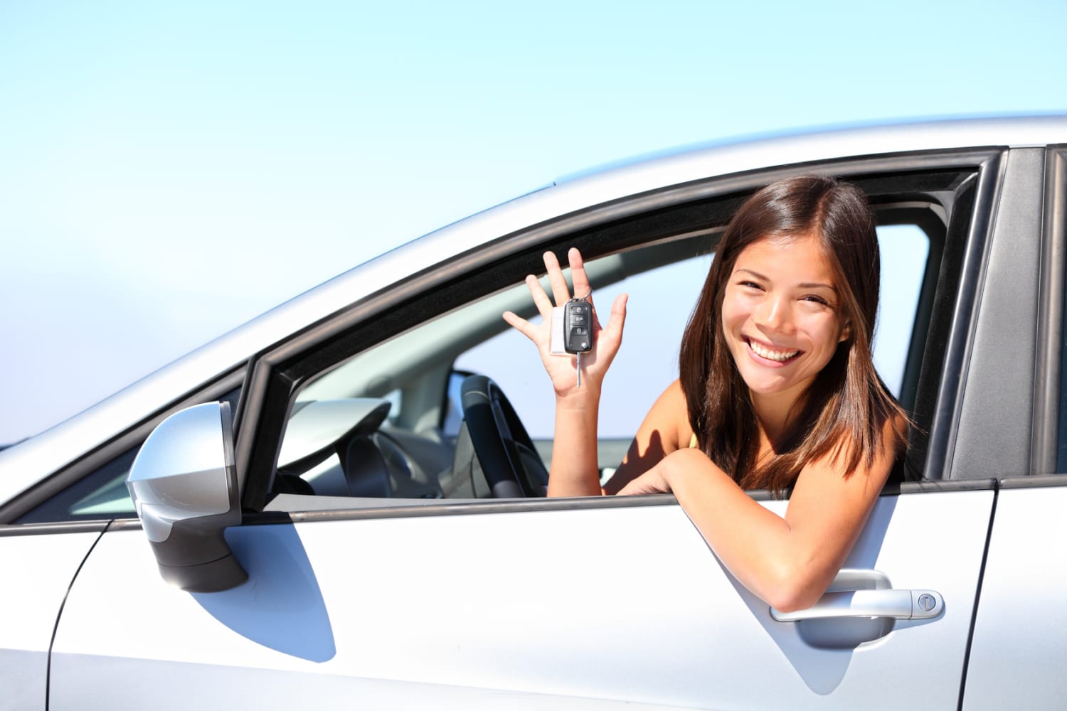 17 year old woman smiling showing new car keys