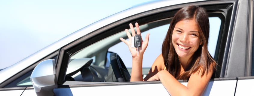 17 year old woman smiling showing new car keys