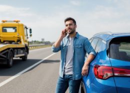 man calling on the side of the road wondering 2026 auto insurance rule changes every driver need to know