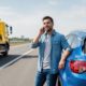 man calling on the side of the road wondering 2026 auto insurance rule changes every driver need to know