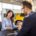 woman is discussing embedded auto insurance with salesman