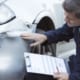 insurance adjuster is inspecting car accident claims