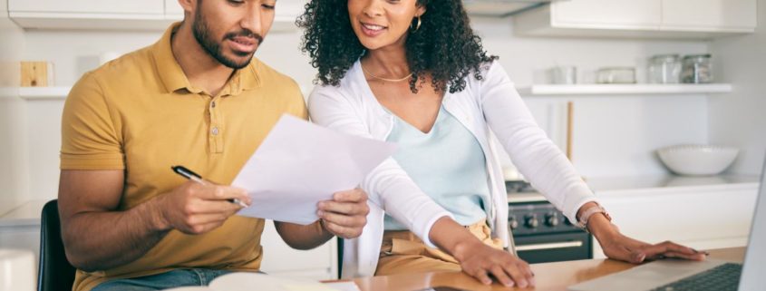 couple sitting in their kitchen reviewing home insurances