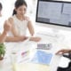 young couple talking to an insurance agent in her office