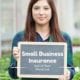 a lady holding a sign saying small business insurance
